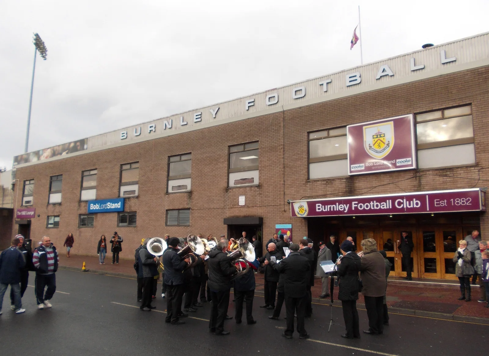 A brass band playing outside Burnley Football Club's Bob Lord Stand on a matchday.