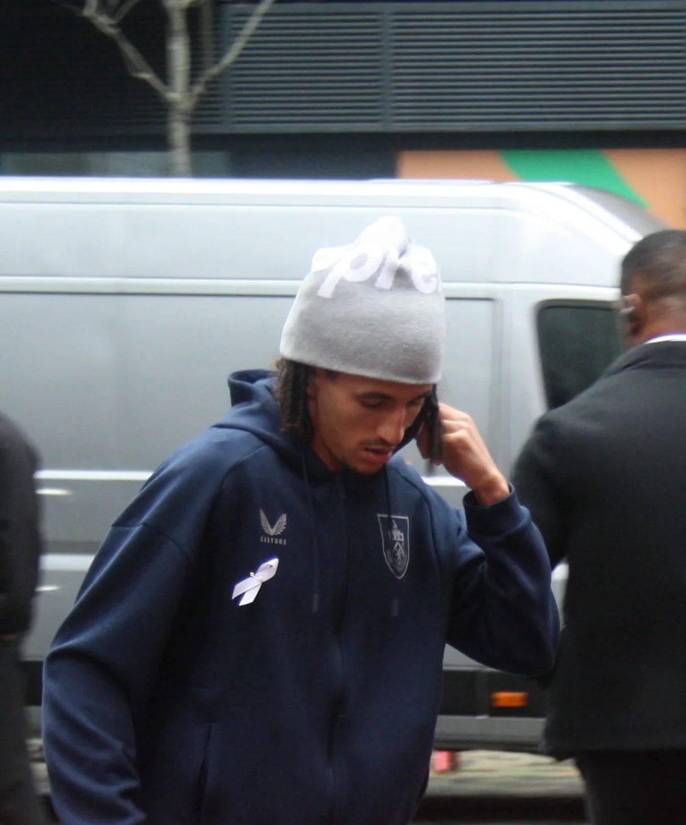 Hannibal Mejbri arriving for a Burnley match in a beanie and club tracksuit.