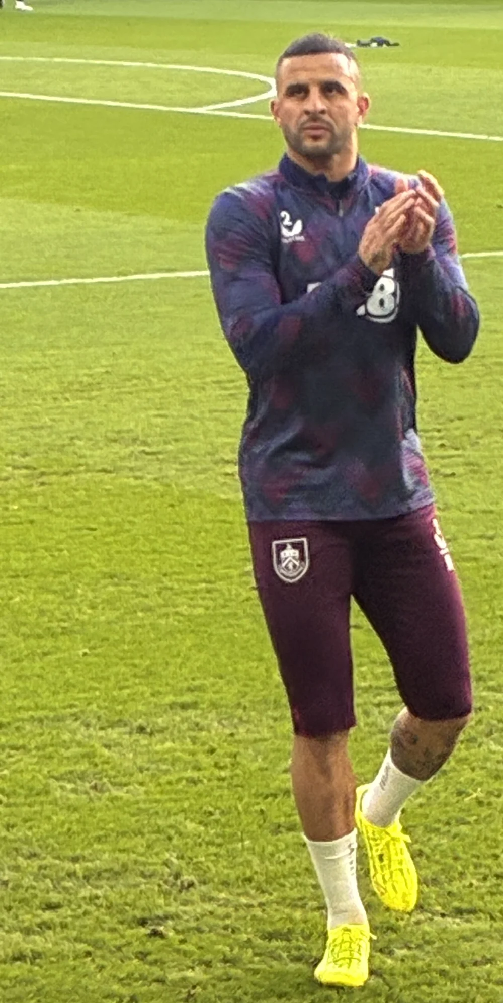 Kyle Walker applauding supporters while warming up in Burnley training kit.