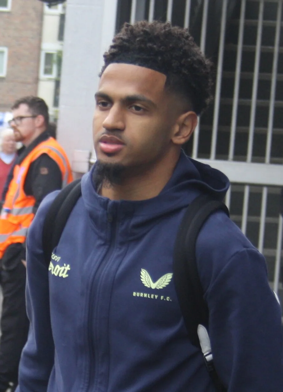 Marcus Edwards arriving for a Burnley match in a navy club tracksuit.