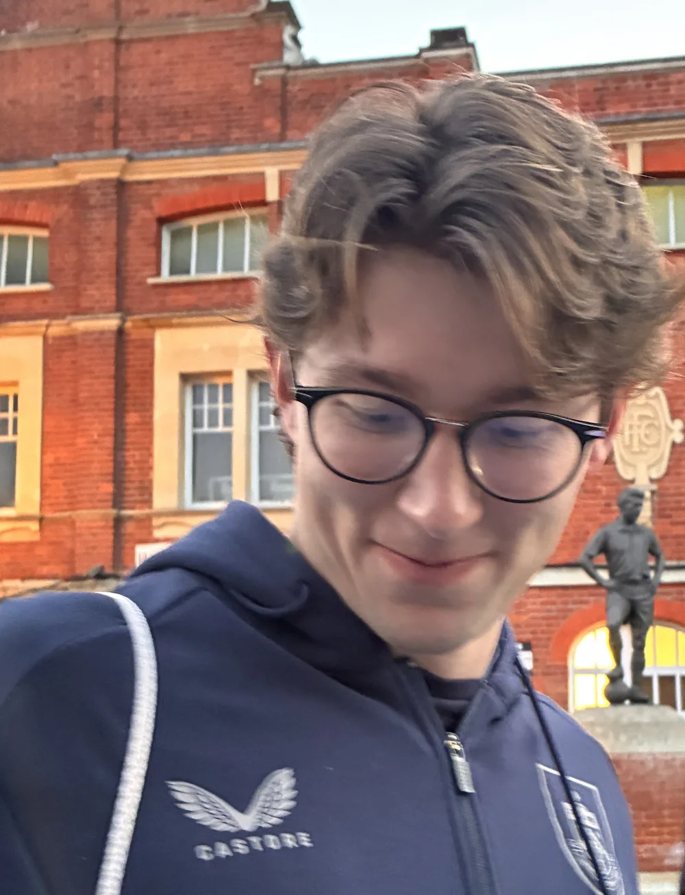 Max Weiß smiling while signing autographs after a Burnley match.